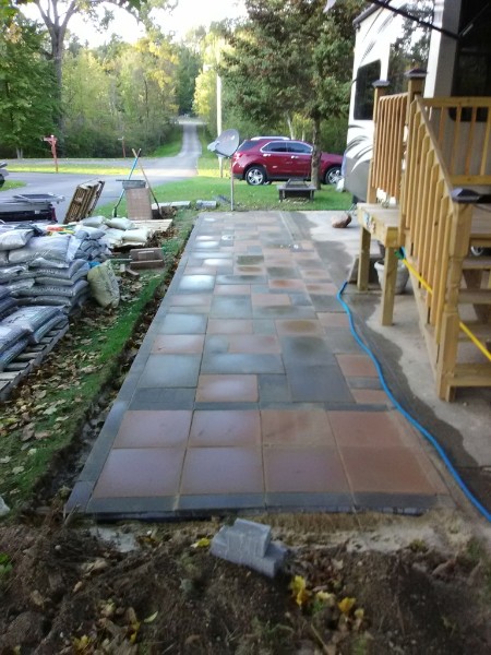 Custom stone patio installation with natural stone pavers